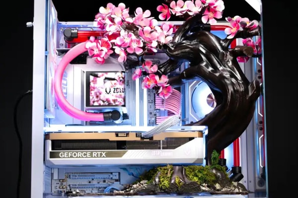 AFTERSHOCK Cherry Bloom gaming PC featuring kinetic titanium blossoms in an APNX V2 chassis.