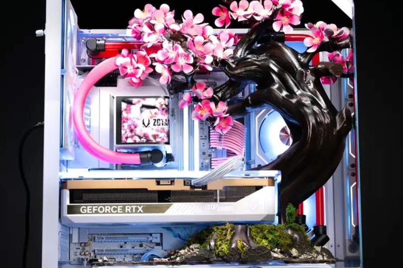 AFTERSHOCK Cherry Bloom gaming PC featuring kinetic titanium blossoms in an APNX V2 chassis.