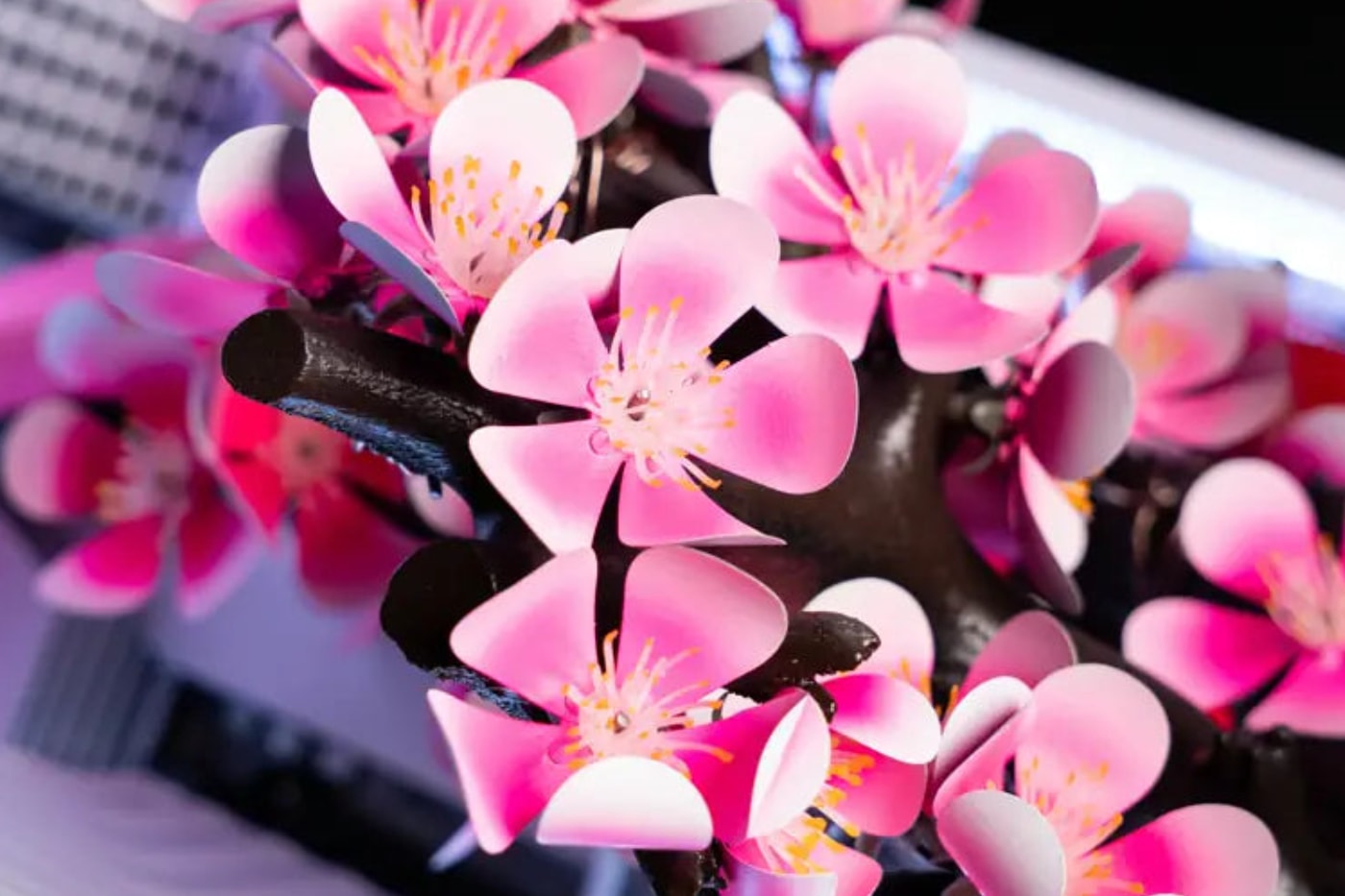 AFTERSHOCK Cherry Bloom gaming PC featuring kinetic titanium blossoms in an APNX V2 chassis.