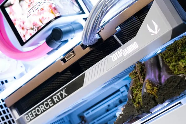 AFTERSHOCK Cherry Bloom gaming PC featuring kinetic titanium blossoms in an APNX V2 chassis.