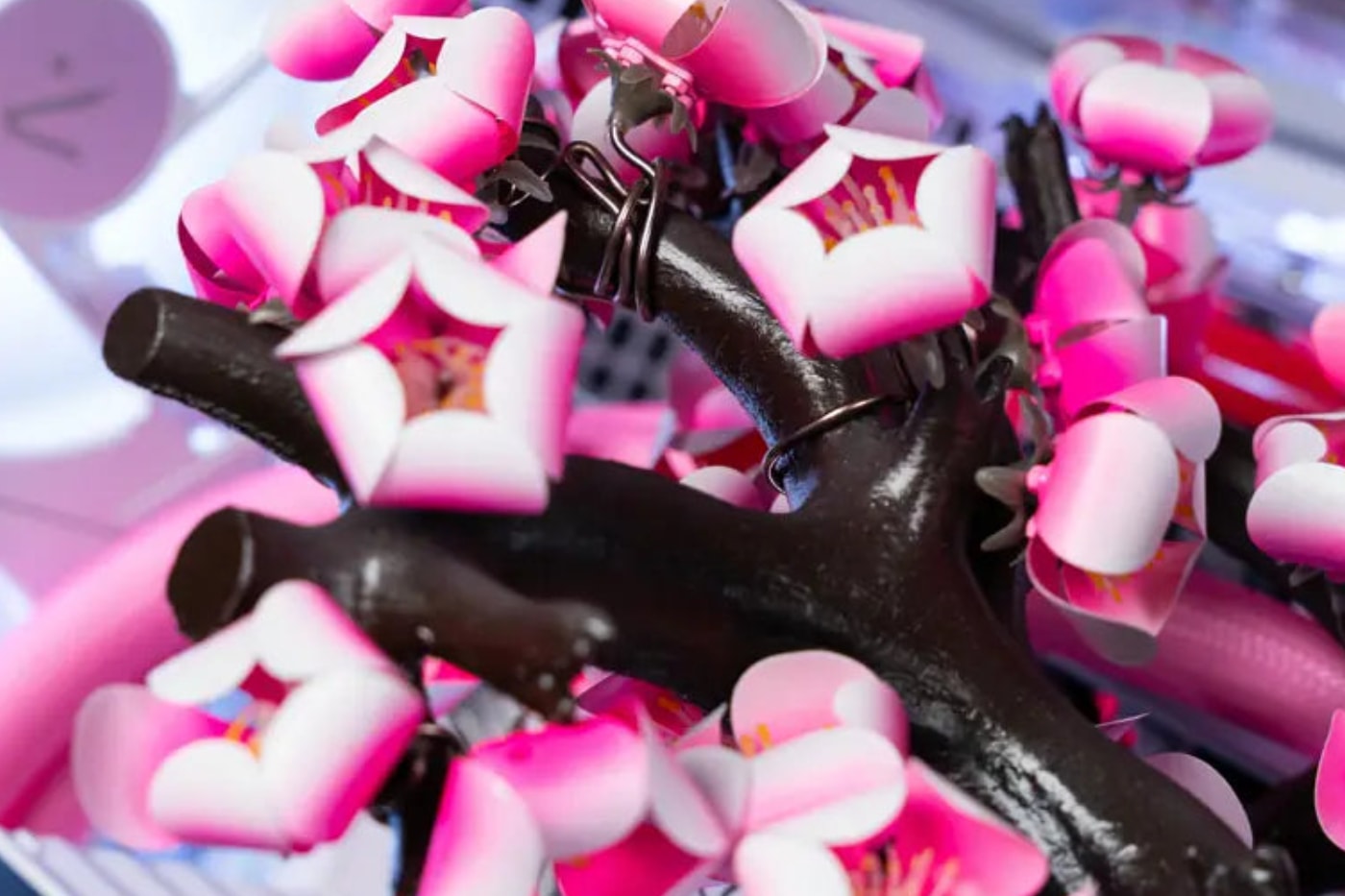 AFTERSHOCK Cherry Bloom gaming PC featuring kinetic titanium blossoms in an APNX V2 chassis.
