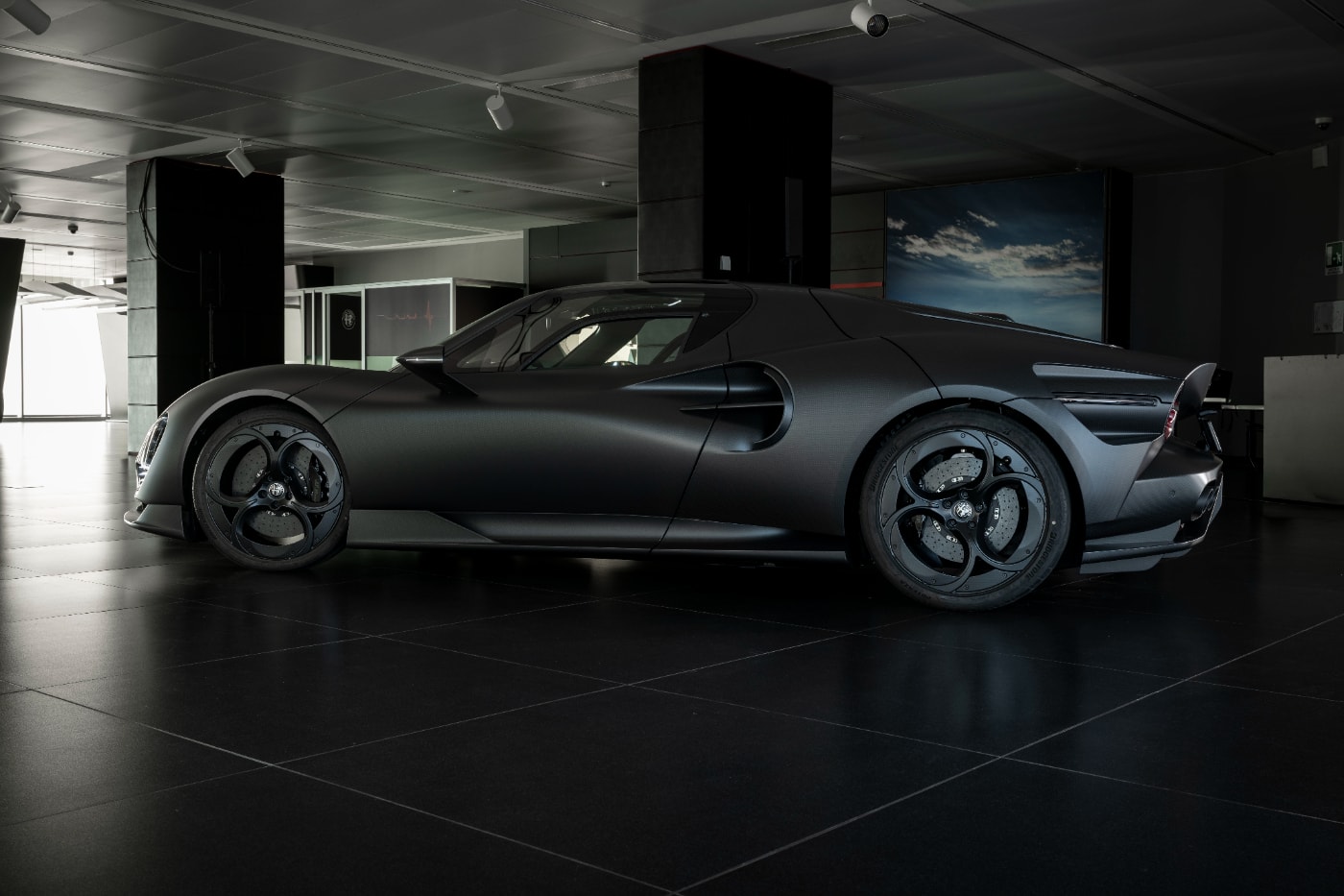 Alfa Romeo 33 Stradale Perla Nera featuring matte black exposed carbon fiber bodywork.