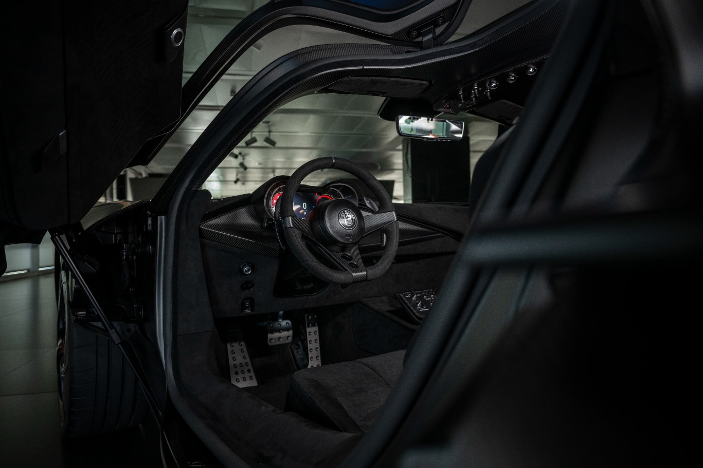 Alfa Romeo 33 Stradale Perla Nera featuring matte black exposed carbon fiber bodywork.