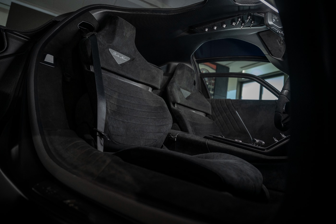 Alfa Romeo 33 Stradale Perla Nera featuring matte black exposed carbon fiber bodywork.