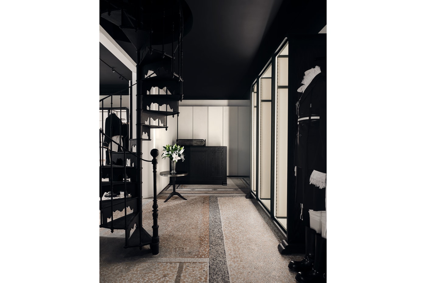 Minimalist interior of the new Ann Demeulemeester Paris flagship store at the Jardin du Palais Royal.