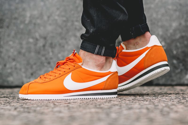 white and orange nike cortez