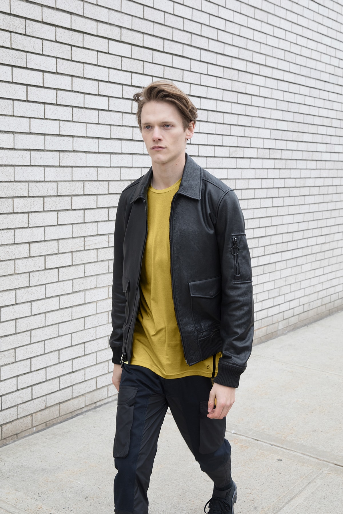 the arrivals mountain wear parkas bombers unisex tees leather jackets yellow shirt brick wall