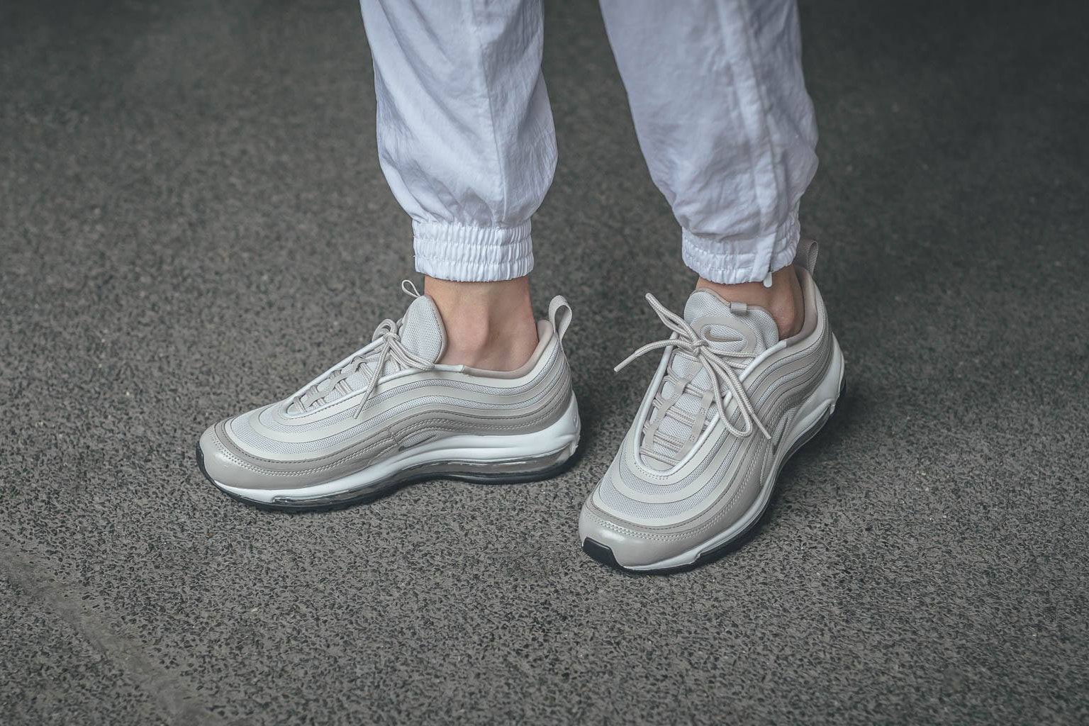 nike air max 97 ultra moon particle leather canvas mesh on foot concrete cement white track pants