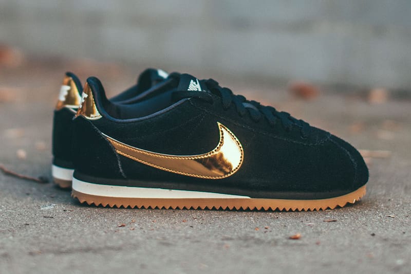 pink nike cortez with gold swoosh