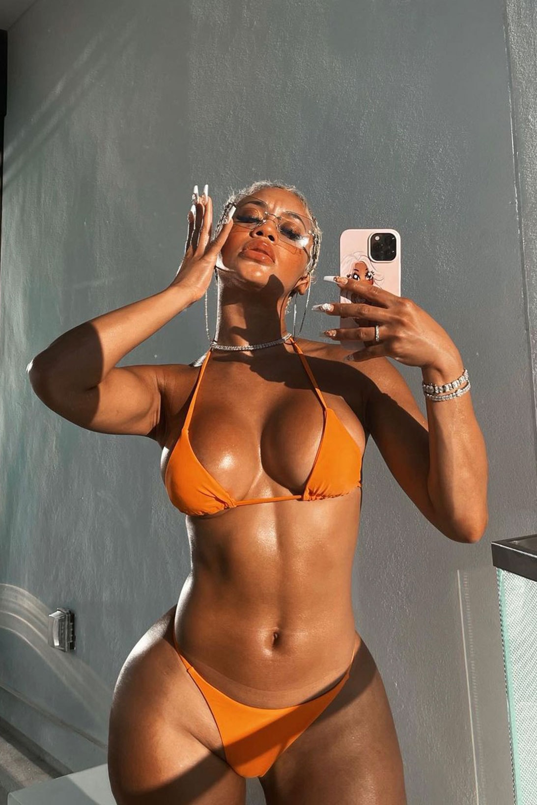 Saweetie orange bikini swimwear swimsuit trend jewelry sunglasses