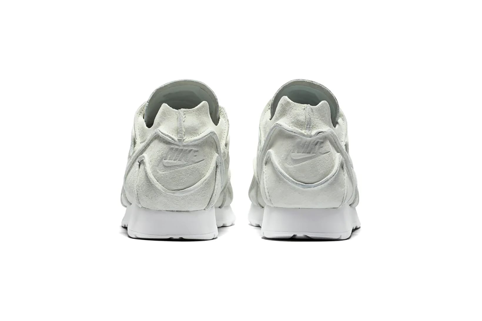 nike outburst trainers in white and green