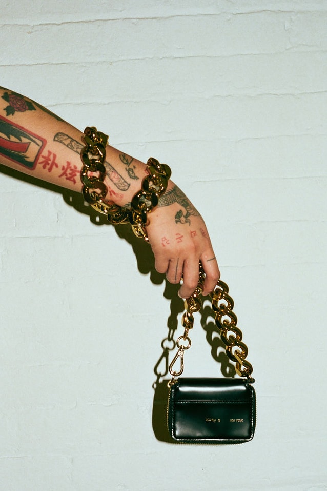 kara bike wallet chain leather mini bag black gold tattoos arm hand