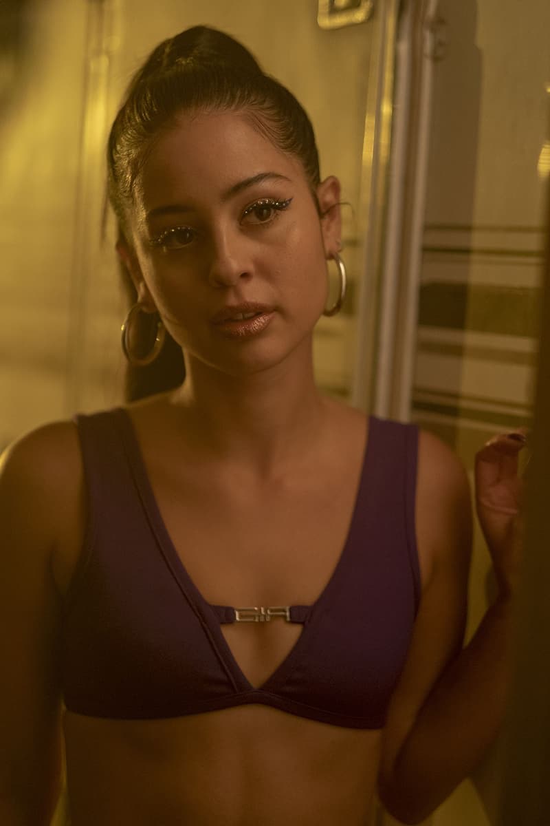 Euphoria Alexa Demie Maddy Makeup Beauty Look Purple Silver Metallic Eyeshadow Black Ponytail Rhinestone Diamond Eye Gold Hoop Earrings I Am GIA Top Bra Bralette HBO TV Show Television