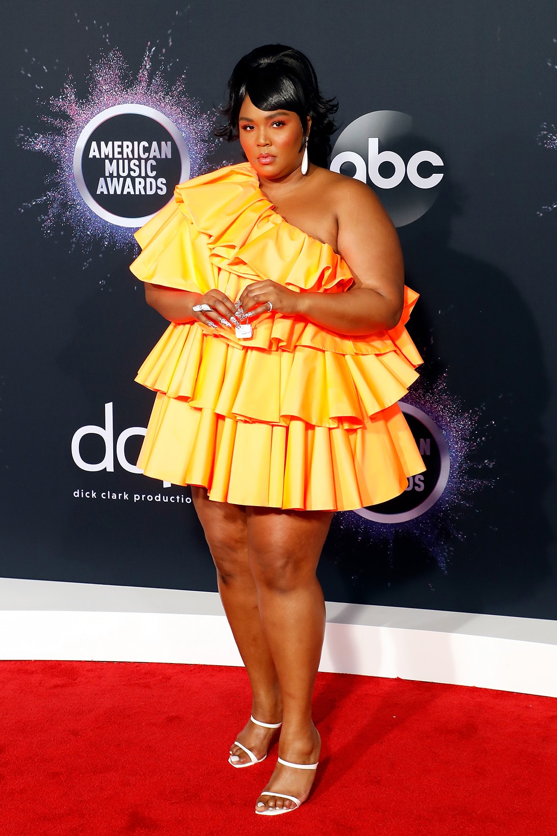american music awards amas best celebrity red carpet looks lizzo valentino orange dress tiny bag heels