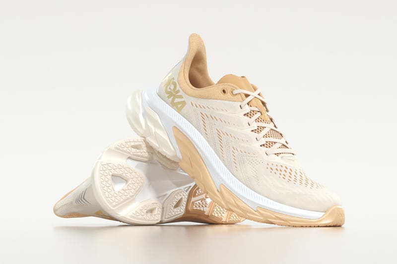 white and gold hoka shoes