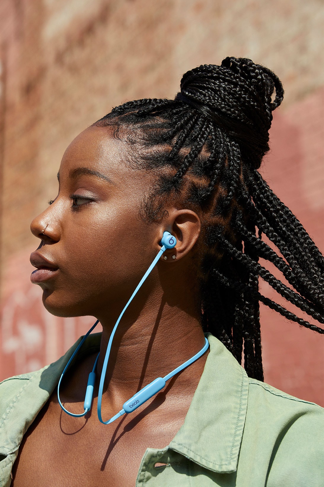 beats flex new colors flame blue wireless earphones headphones listening music brick wall