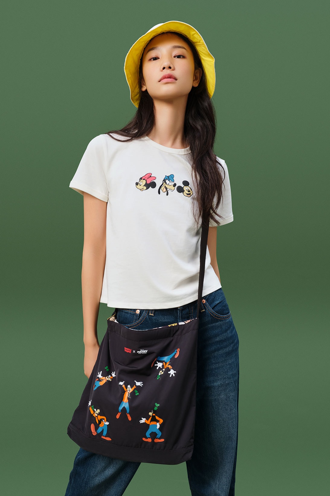 disney levis mickey and friends collaboation denim jeans white tee shirt yellow bucket hat bag crossbody