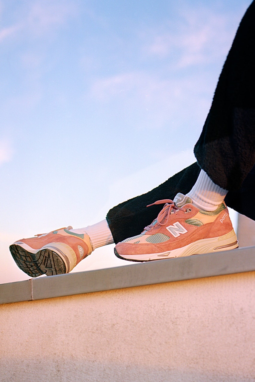 patta new balance nb 991 collaboration sneakers peach coral orange on-foot roof sunlight sky