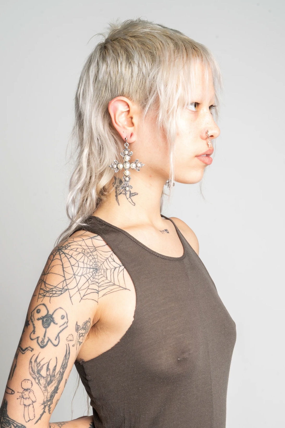 ohtnyc rising new york designer jinsol woo piercing cross chain earring tank top