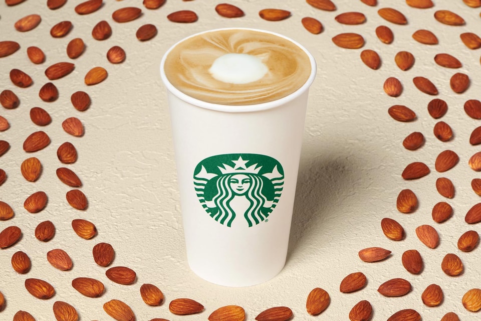 Homey almond flat white Starbucks drink surrounded by almonds Homey almond flat white Starbucks drink surrounded by almonds