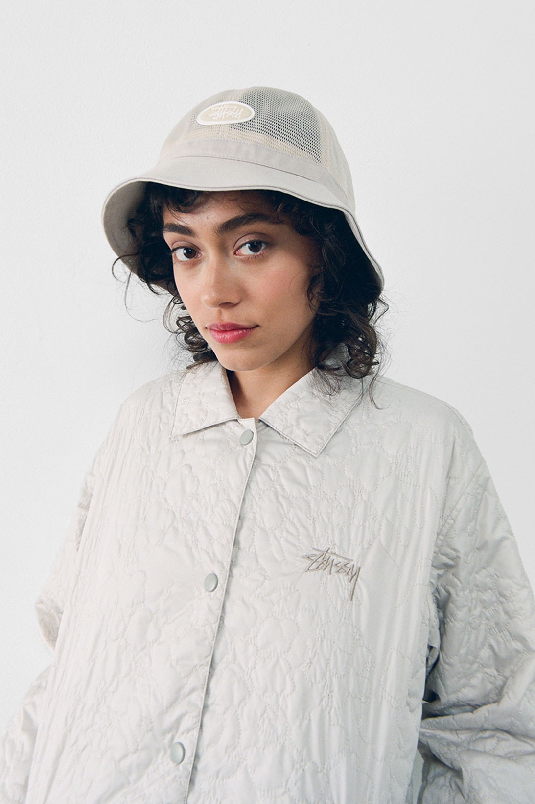 stussy spring 2021 collection lookbook womenswear white quilted jacket mesh bucket hat