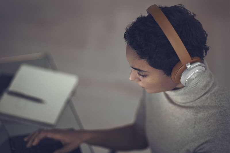 bang and olufsen beoplay hx headphones listening music timber tan brown