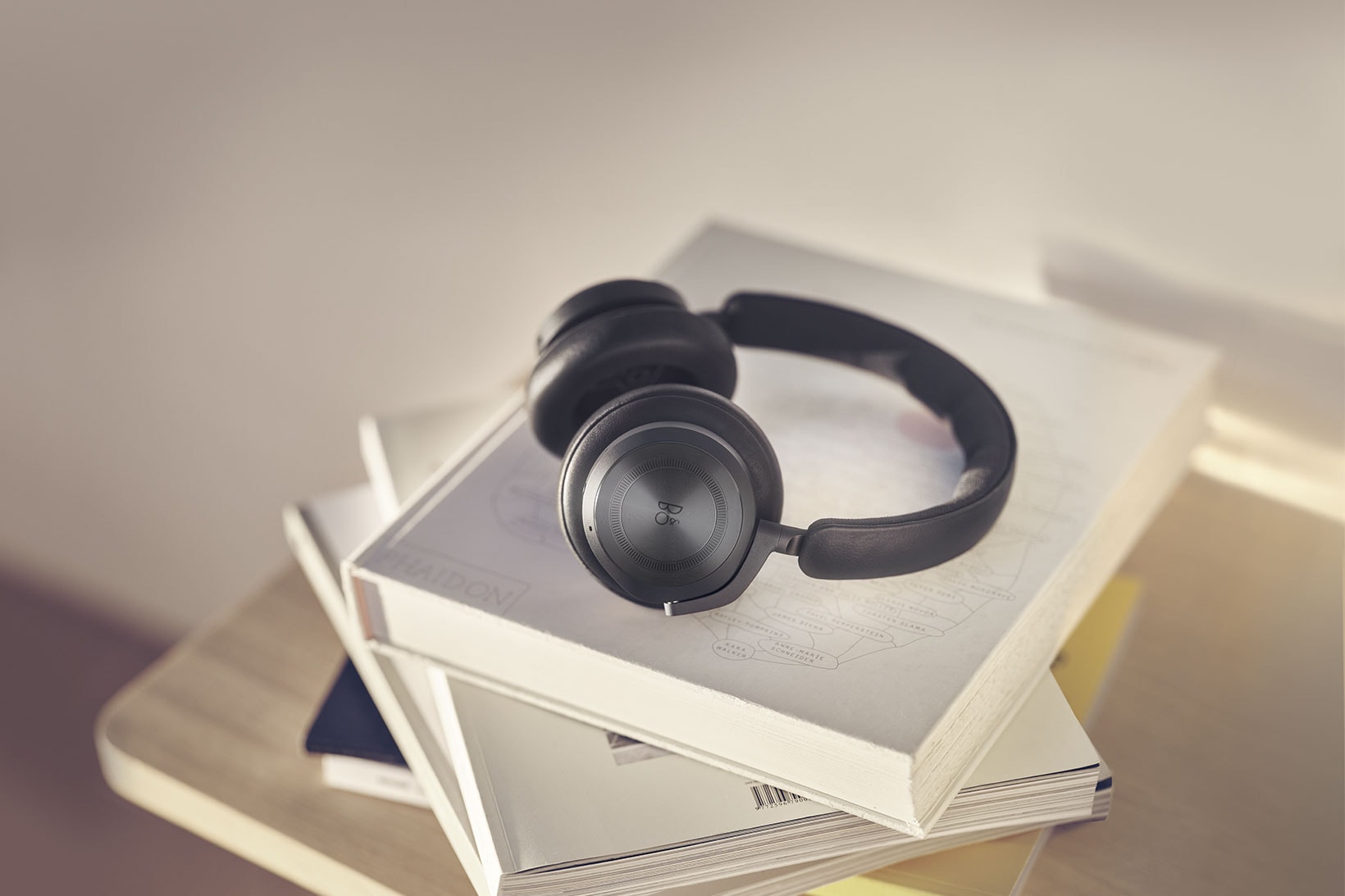 bang and olufsen beoplay hx headphones listening music black anthracite books