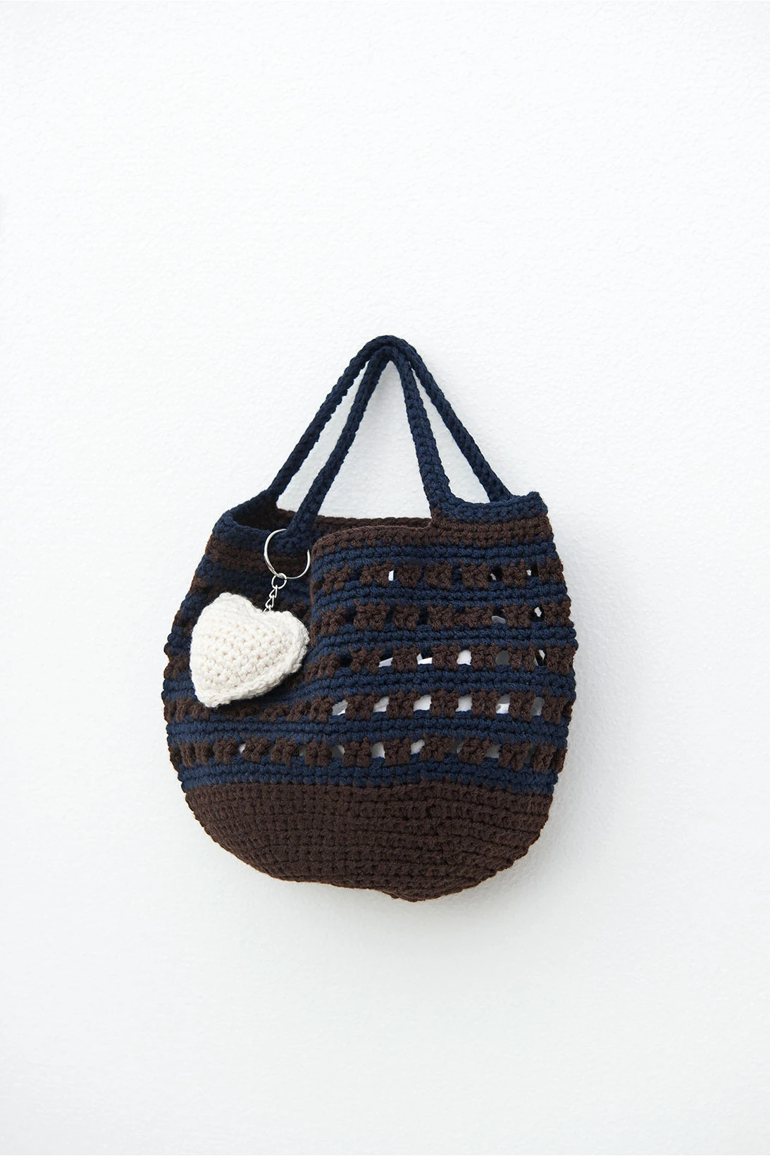 ganni kiosk sustainable accessories collection leftover fabrics crochet knit handbags heart keychain