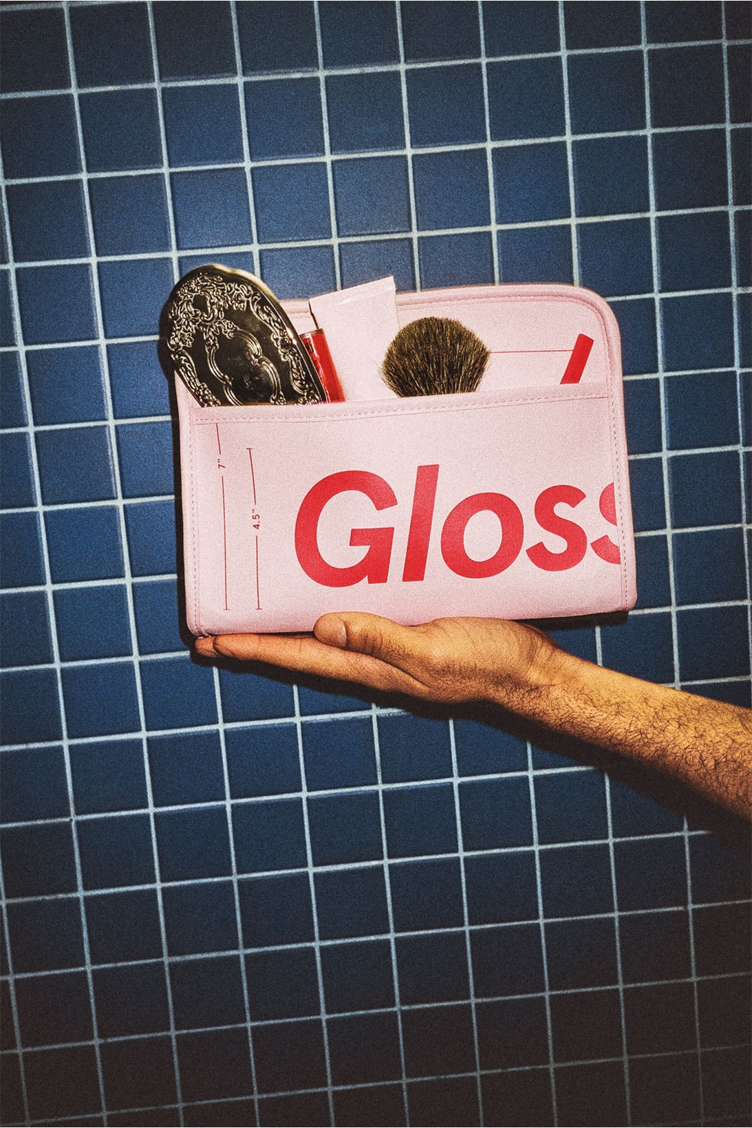 glossier the beauty bag pink red makeup skincare pouch shower bathroom tiles hand