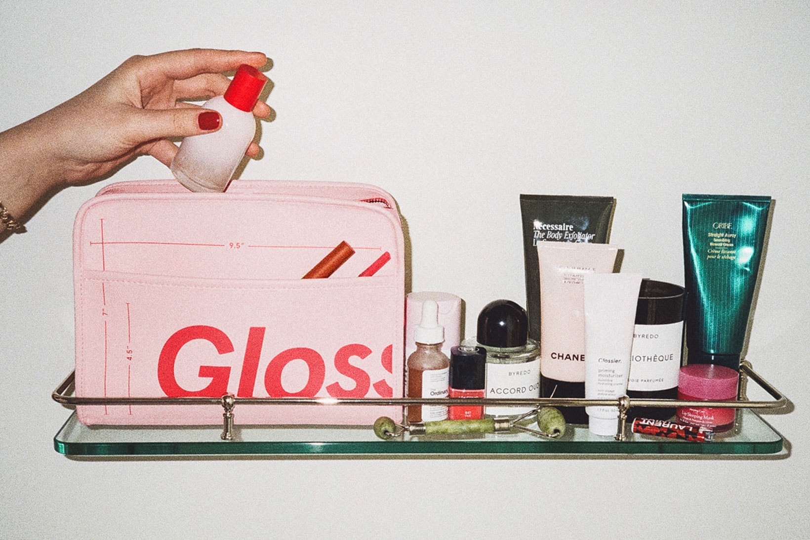 glossier the beauty bag pink red makeup skincare pouch bathroom sink shelf vanity