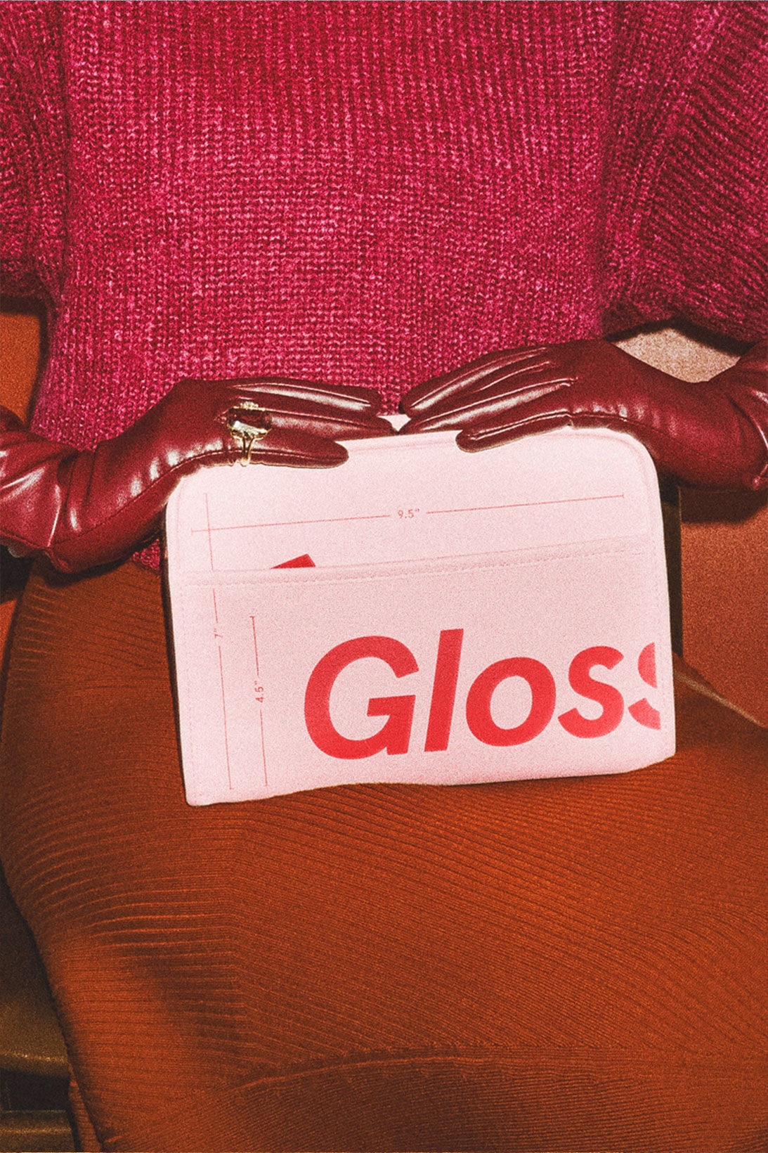 glossier the beauty bag pink red makeup skincare pouch knitwear gloves skirt