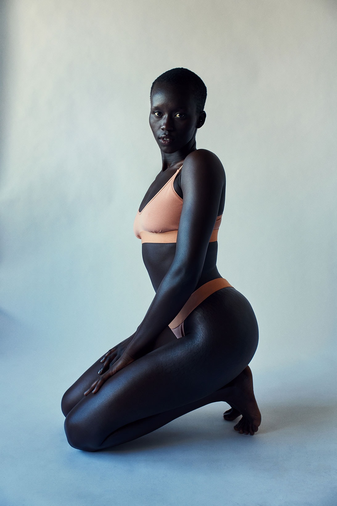 kotn sustainable underwear collection ethically made cotton bras bikini orange coral model