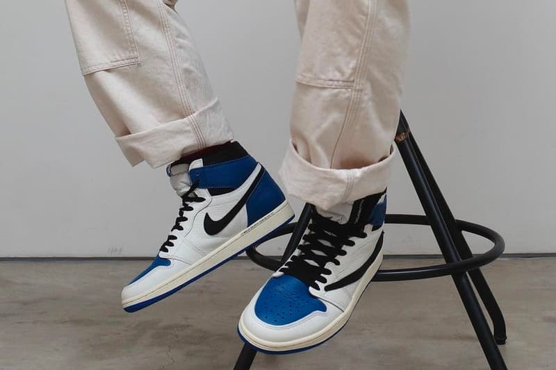 travis scott fragment design air jordan 1 aj1 high og military blue closer look stool sitting on foot