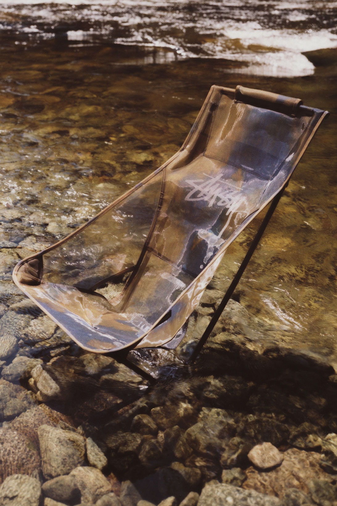 stussy helinox collaboration camping outdoor chair rocks water
