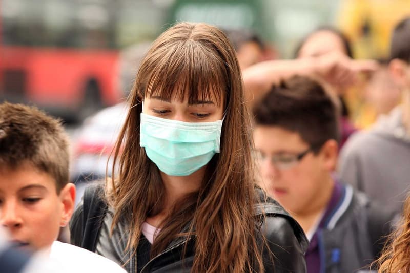 Woman Wearing Face Mask Outside Crowd