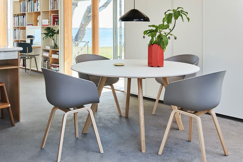 HAY white table and grey chairs with red vase