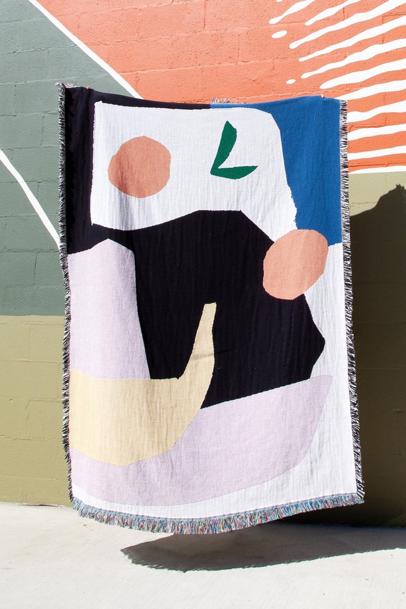 Slowdown Studio's "MOOENY" throw on a colorful wall