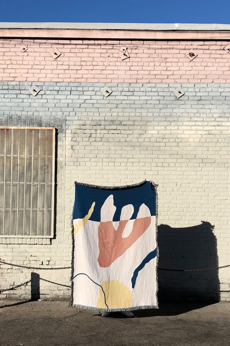 Slowdown Studio's "FRANKLIN" throw behind a pastel building