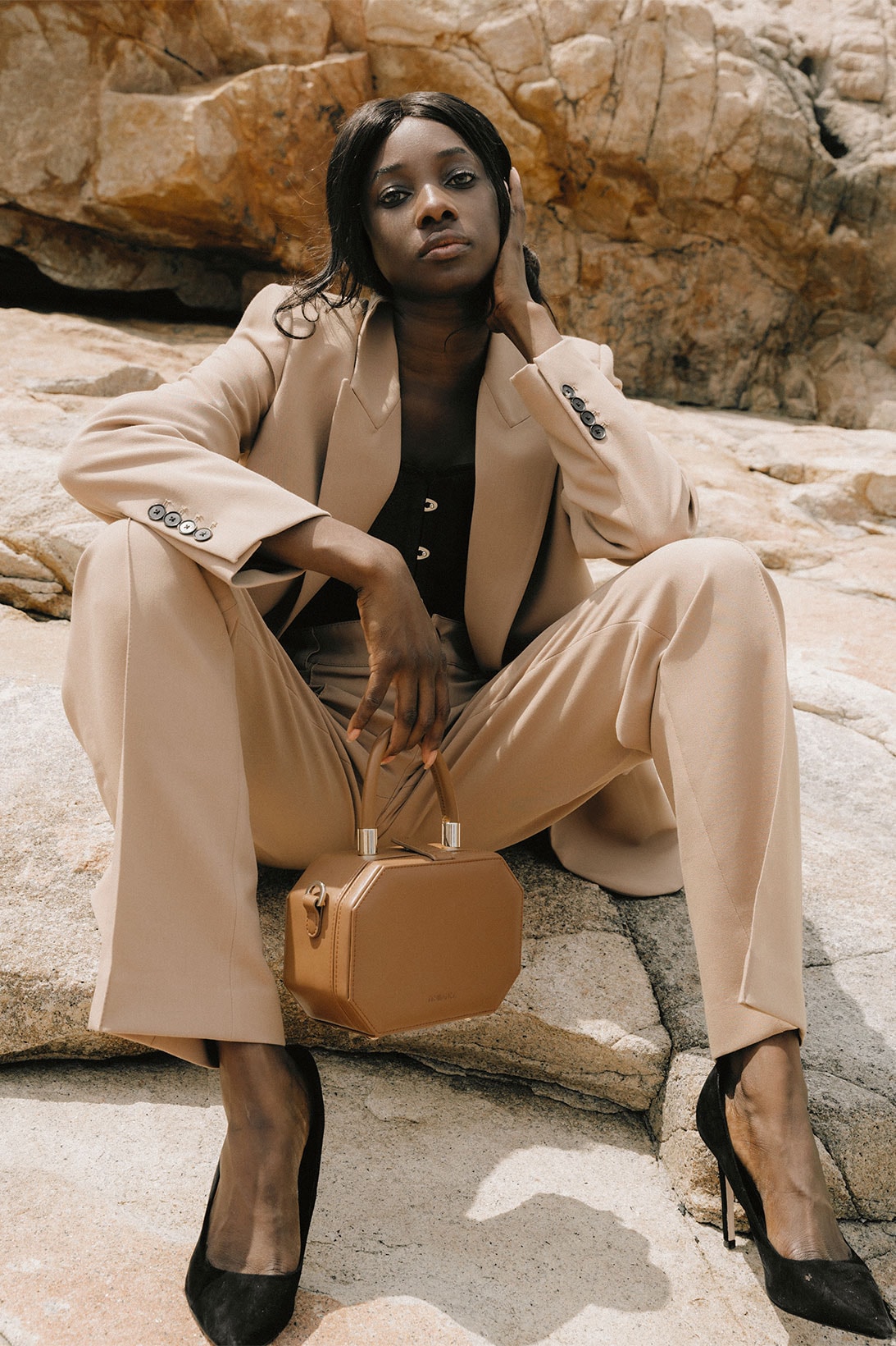 Noiranca Brown Bag on model sitting in desert