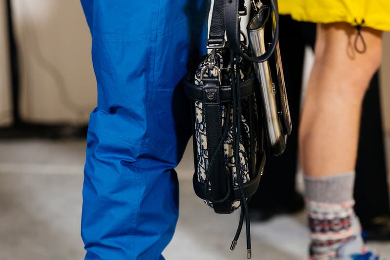 dior mens pre fall 2022 runway show blue pants black dior bag