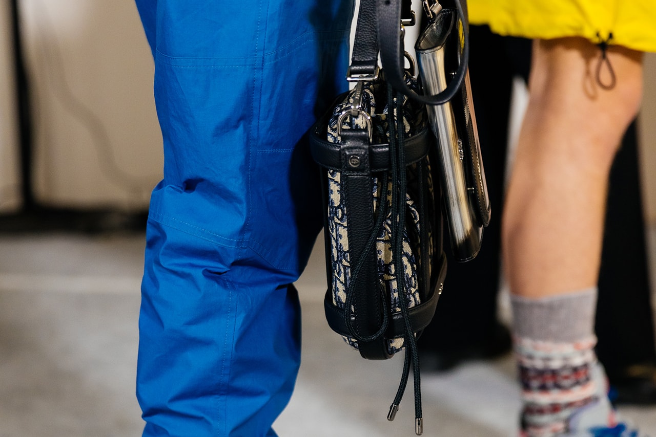 dior mens pre fall 2022 runway show blue pants black dior bag