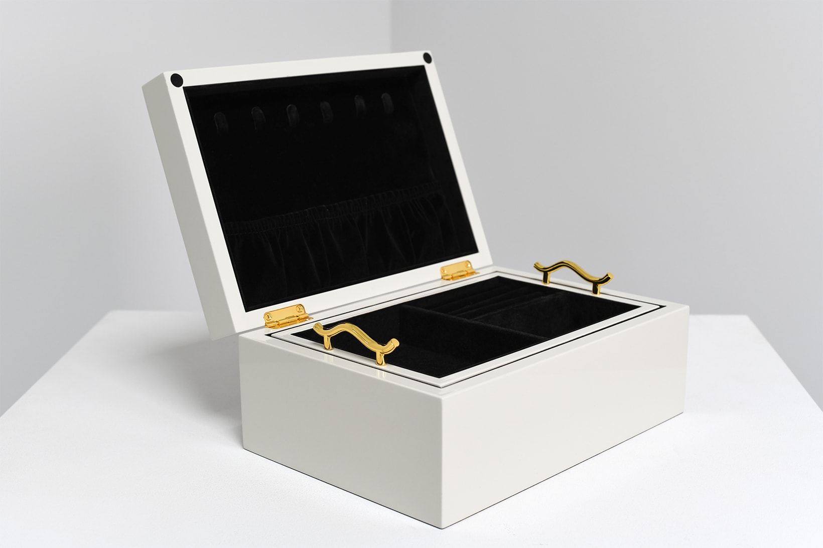 The inside of the white jewelry box