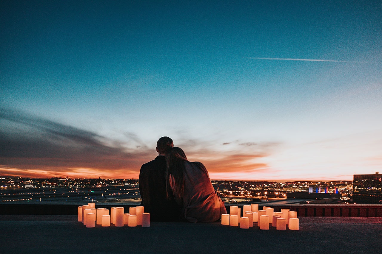 Couple on romantic date facing city view