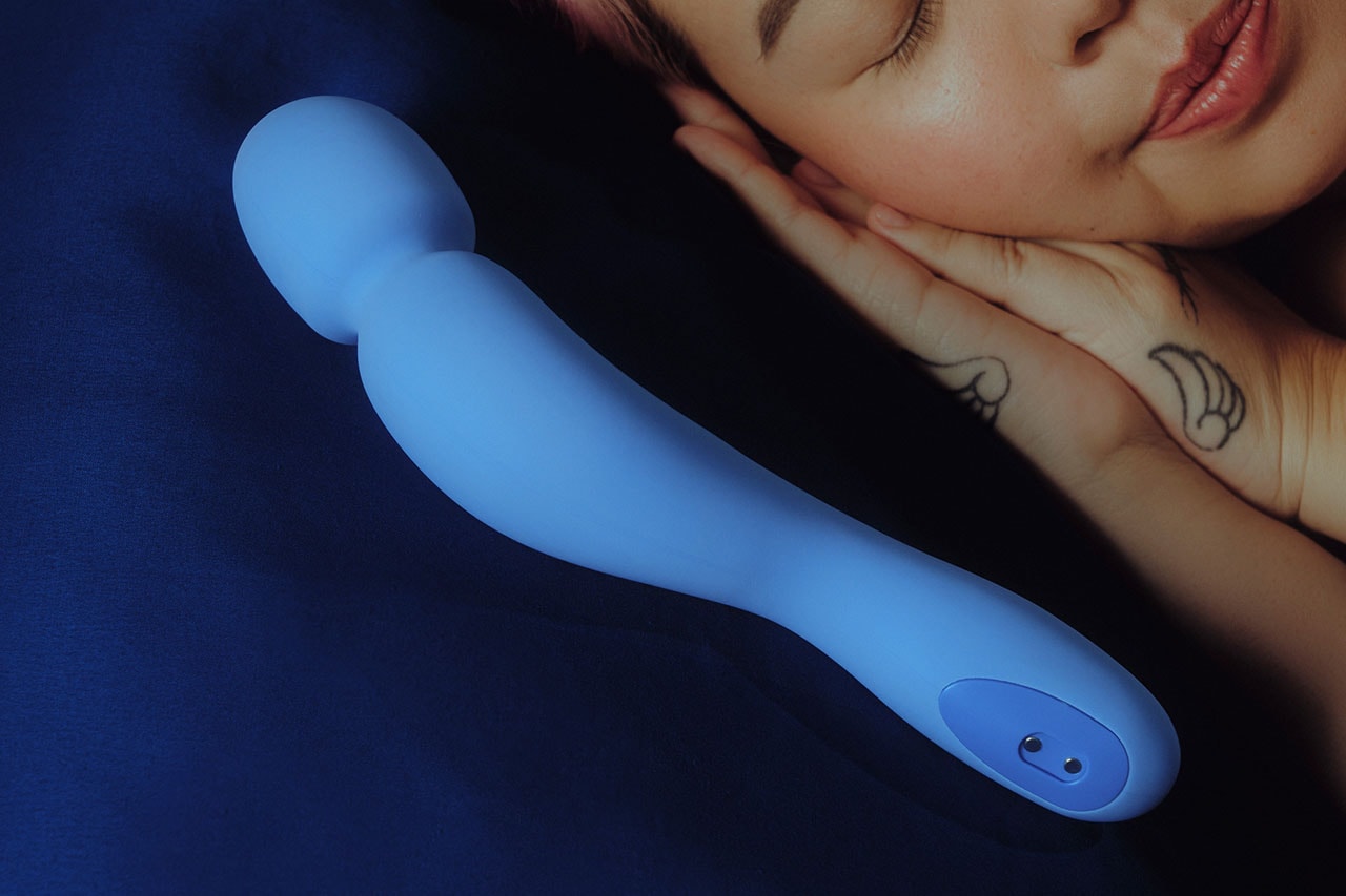 Dame Products Com Sex Toy Wand Vibrator Periwinkle Blue Lying Next to Playmate