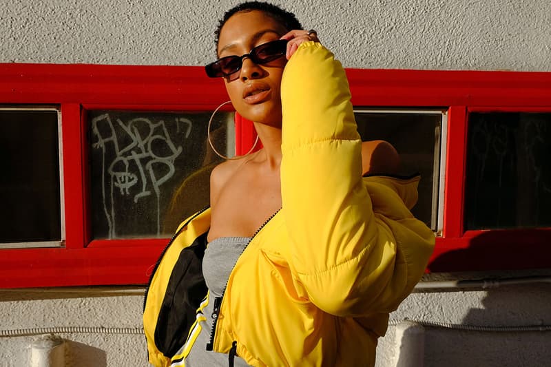 Gen Z woman holding sunglasses and posing