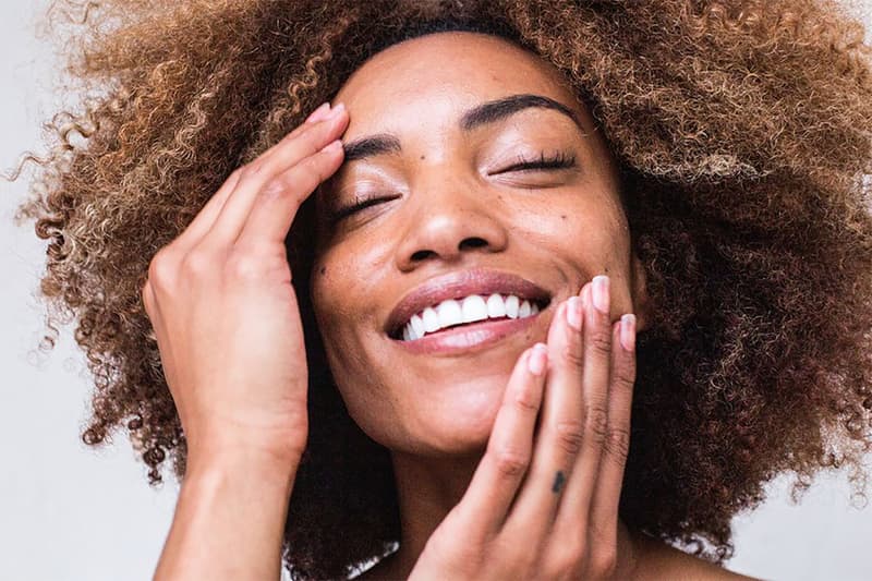 Black Woman Applying Skin Care