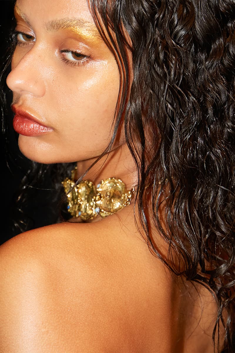 Woman with wavy hair and gold necklace