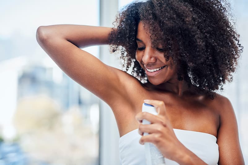 Woman applying deodorant