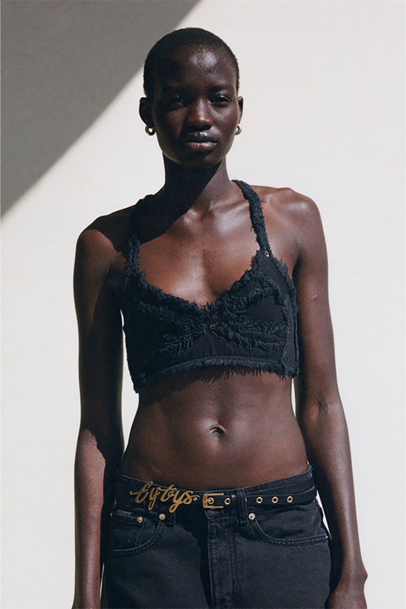 Cropped View Of Woman In Lace Bra And Jeans On Black Background