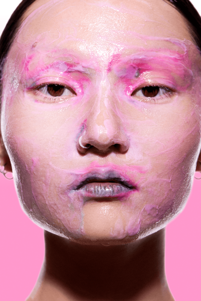 futurewise, korean skincare, slugging, woman with bright makeup wiping her band on face, cleanser